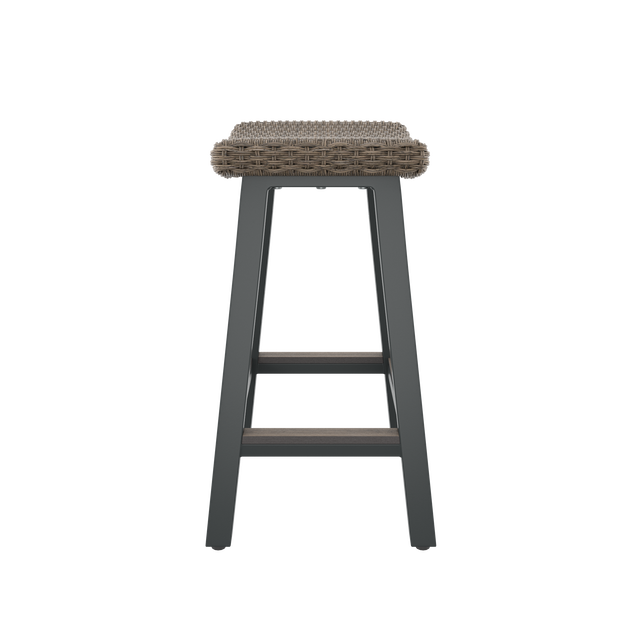 Side of brown bar stool with contoured seat and footrest