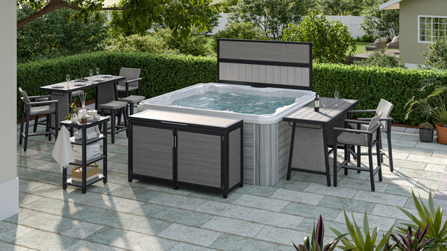 Gray colored dining tables, privacy screen, bar chairs, deck box, and towel holder surrounding outdoor hot tub