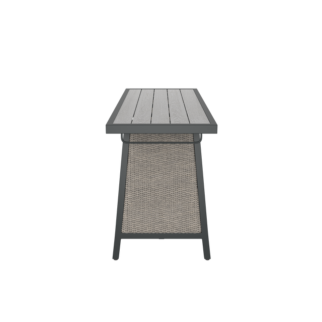 Side of gray dining table with wood effect top, wicker side, and towel rack