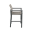 Side of gray high-backed bar chair with armrests and footrest 